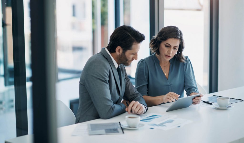 Business people, teamwork and tablet for statistics, finance report and planning of revenue, profit or sales in office. Professional advisor or clients with data analytics, graphs and digital charts