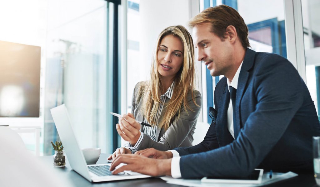 Cropped shot of two businesspeople working together on a laptop